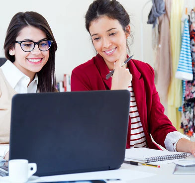 files/two-young-businesswomen-working-with-laptop-her-office_1301-6823.webp