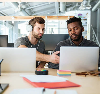 files/young-serious-colleagues-sitting-office-coworking_171337-17707.webp